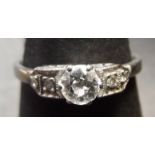 Precious metal single stone diamond ring, the brilliant cut diamond (0.25ct app), the shoulders each