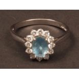 18ct white gold aquamarine and diamond ring, the oval faceted aquamarine (0.73ct app) surrounded