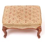 Small 19th century walnut foot stool with floral embroidered seats, shaped frieze and raised on four