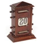 Early 20th century stained walnut cased desk calendar, of rectangular form with faceted pediment and