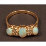 Antique opal and diamond ring, the three oval shaped cabochon cut opals with four small single cut