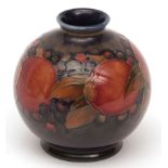 Moorcroft small globular spill vase, decorate with a pomegranate design, incised signature and