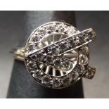 Precious metal diamond cluster ring, a stylised letter V entwined with the letter O design, set