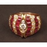 Modern 18ct gold ruby and diamond cluster ring, the centre set with three graduated brilliant cut