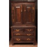 18th century oak cabinet, the upper section with two doors of central fielded panels, the lower