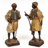 Two cold painted spelter models of figures in Eastern dress, one clutching a musket and the other