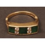 18ct gold three stone emerald and diamond ring, the row of three square cut emeralds, spaced by