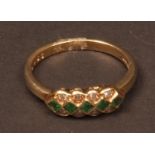 Modern 18ct gold emerald and diamond ring, set with a row of five square cut emeralds with eight