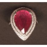 Precious metal diamond and ruby ring set with a pear cut ruby (8.30ct app) in a two-tier surround of