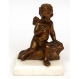 Bronze figure of a seated winged putto mounted on a marble socle, 6" high