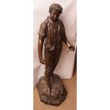 Large bronze patinated spelter figure of a gardener clutching a floral sprig in his left hand and