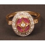 Modern 18ct gold ruby and diamond oval cluster ring, the centre single cut diamond between four oval