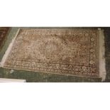20th century machine made silk mix carpet decorated with floral motifs on a pale background, 63"