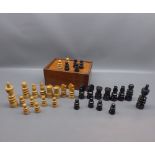 Box of vintage carved wooden chess pieces