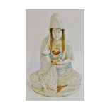 Japanese porcelain figure of Kwannon, seated cross legged and holding a scroll, 10 1/4" high,