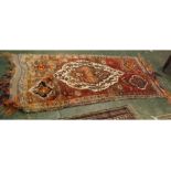 20th century Turkish wool floor rug, decorated with central lozenge, 85" long