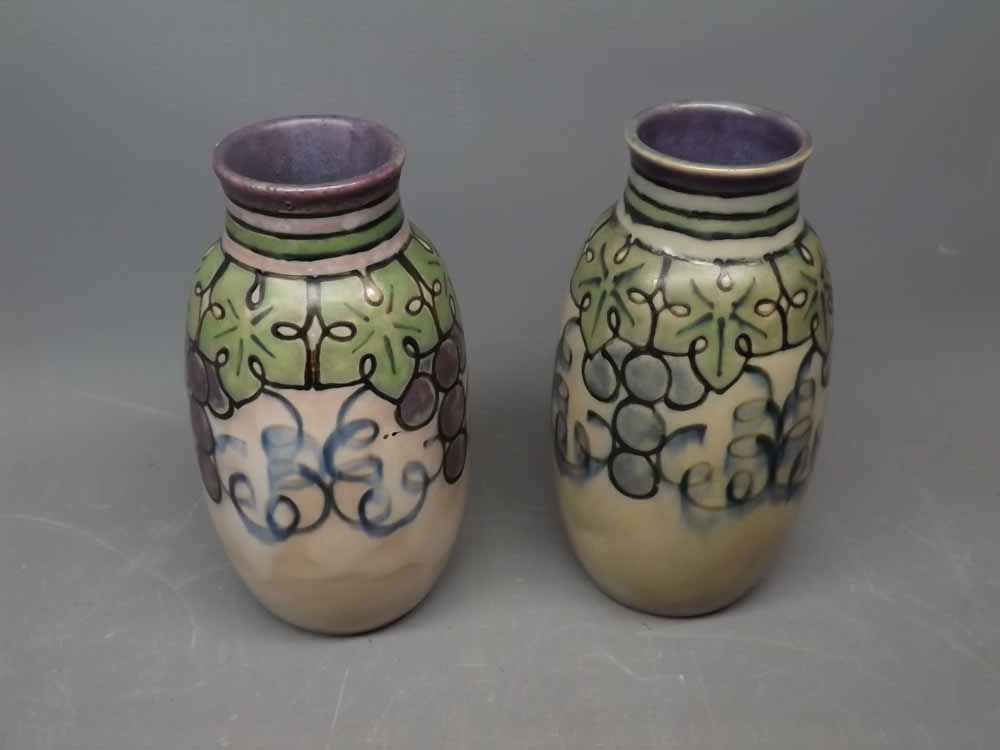 Pair of Royal Doulton stoneware vases of baluster form decorated with stylised grapes and vine