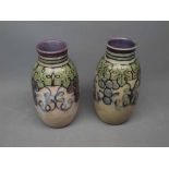 Pair of Royal Doulton stoneware vases of baluster form decorated with stylised grapes and vine
