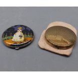 Two vintage circular compacts, one decorated with a crinoline lady to front