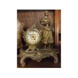 Late 19th or early 20th century continental gilt metal bedside timepiece, with figural mount
