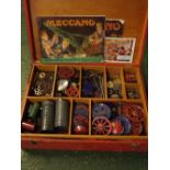 Red painted plywood box: assorted Meccano pieces, to include wheels, links, panels and assorted