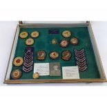 An inter-war cased set of cloth badges, SMRC International Small Bore including 1923, 24, 25, 26,