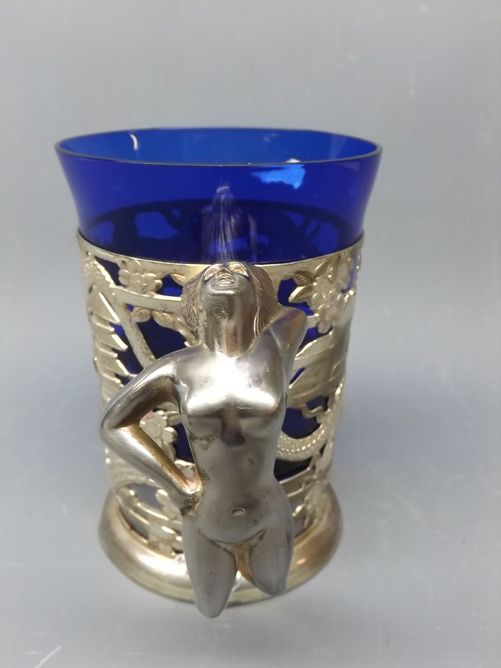 Unusual oriental silvered metal musical tankard, with chinoiserie piercing, nude female figure