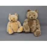 Two 20th century Steiff teddy bears, with moveable arms and legs and glass eyes, with puce