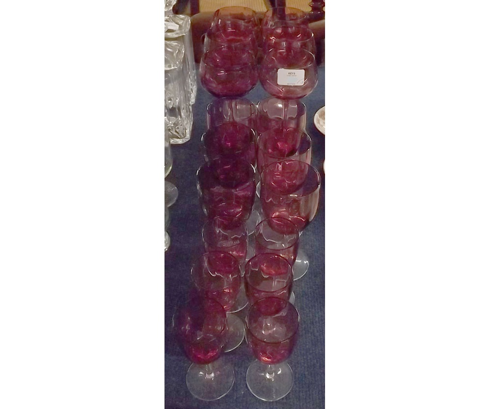 Group of eighteen cranberry and clear glass drinking glasses, largest set 7 1/2" high