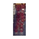 Group of eighteen cranberry and clear glass drinking glasses, largest set 7 1/2" high