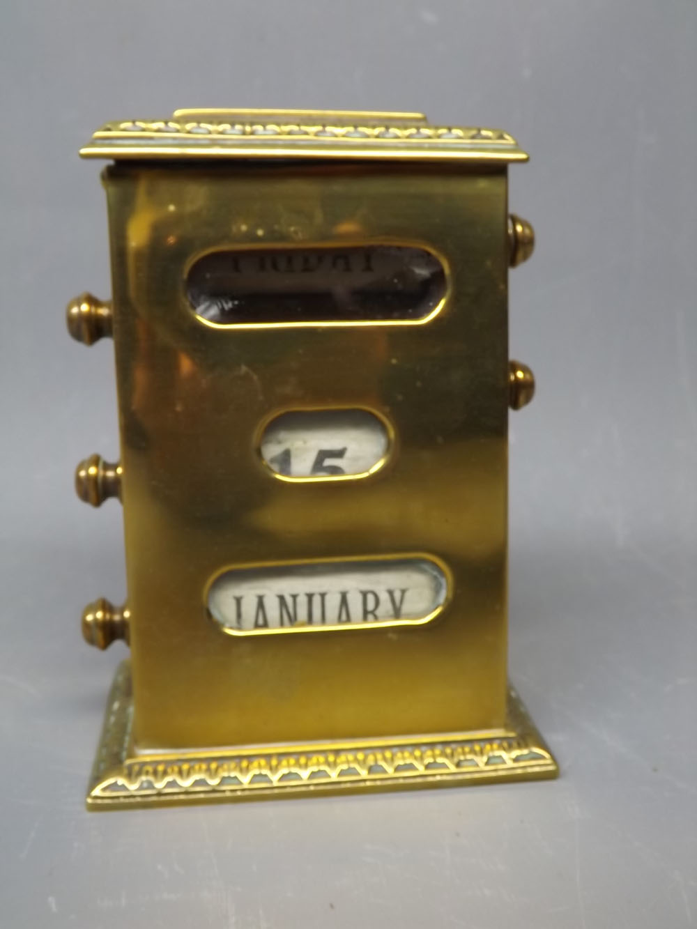 Late Victorian brass cased perpetual calendar of rectangular form, with sloping top, side adjusters,