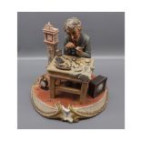 Capo di Monte model of a watchmaker seated at a workbench, 8" tall