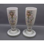 Pair of 19th century French glass vases, with gilded urn and floral decoration on a stepped base,