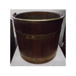 Oak and brass bound cylindrical bucket with swing handle and riveted detail, 12" diameter x 11" high