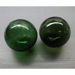 Two green glass decorative balls, 5" diameter