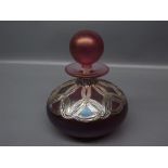 Squat glass small scent bottle, with white metal circles of an interlocking design, together with