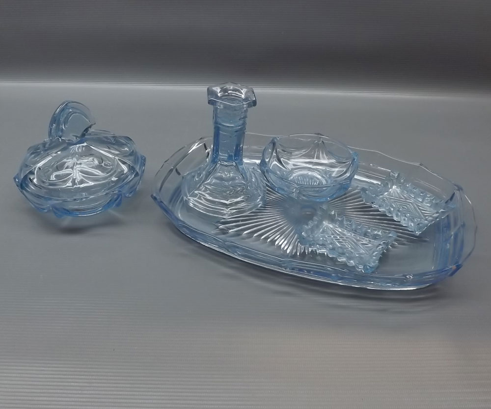 20th century blue glass part dressing table set, comprising single candle stick, tray, lidded