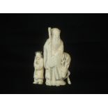 Japanese Meiji period ivory Okimono carved as an Elder with young child carrying a basket and a