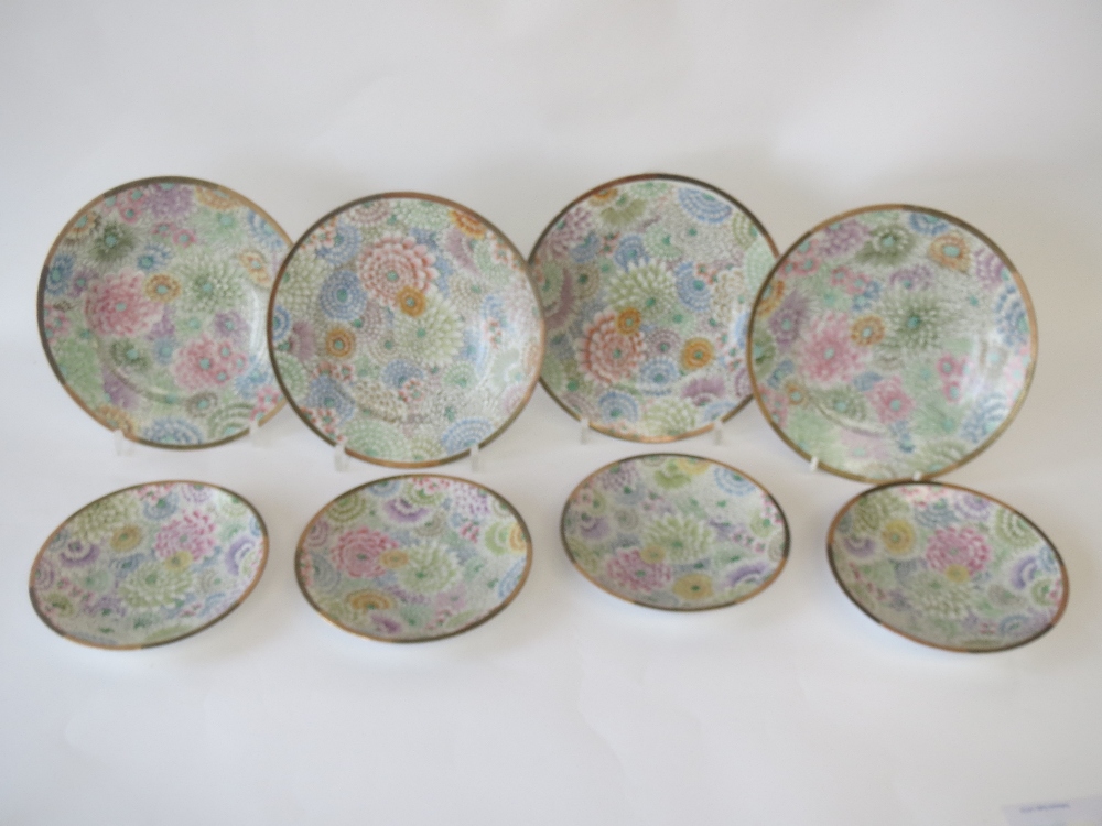 Set of four Japanese tea plates decorated multicoloured chrysanthemums to a black and gilt border