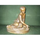 C19th patinated bronze of a young woman kneeling with plaited hair, an oval base, 29cm high