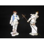 Small pair of continental classical figure, a man carrying a pikestaff, the other hands across his