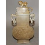 Chinese jade-like vase of archaic form, with double loos ring handles, the sides decorated with