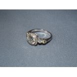Diamond single stone ring, round brilliant cut diamond, within a collet setting to diamond set
