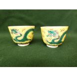 Pair of 19th Century Chinese tea bowls painted with dragons and pearl on a yellow ground, four