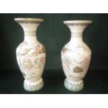 Pair of Japanese Satsuma pottery vases with figures in a landscape 39 cm H