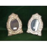 Pair of hallmarked silver photo frames, with embossed cherubs and flowers