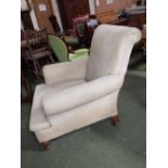 Victorian Howard style arm chair upholstered in beige fabric on mahogany legs to castors