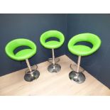 Three contemporary designer style chrome bar stools with lime green leather seats
