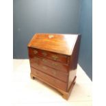 George III mahogany bureau, the fall front revealing an arrangement of drawers around a central