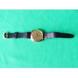 1970s style gold plated Omega De Ville Automatic men's wrist watch on a black leather strap